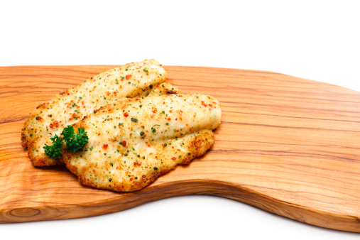 Fillets of Tilapia fish on a cutting board